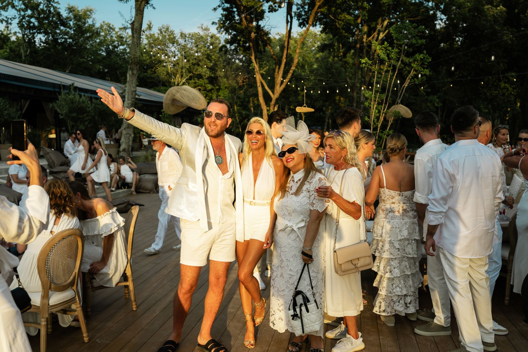 Guests celebrating at a White Party in the D'Orangerie garden